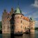 A castle surrounded by a murky moat